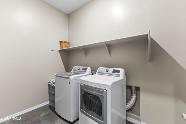 clothes washing area with washer and clothes dryer