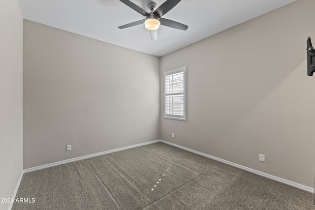 empty room featuring carpet floors, baseboards, and ceiling fan