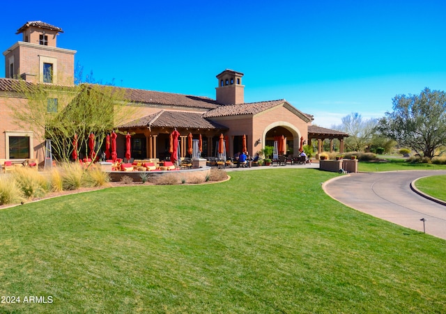 rear view of property featuring a yard