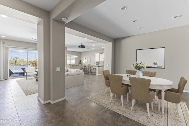 dining area with a wealth of natural light, recessed lighting, visible vents, and baseboards