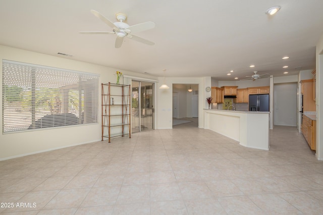 unfurnished living room with baseboards, recessed lighting, visible vents, and ceiling fan