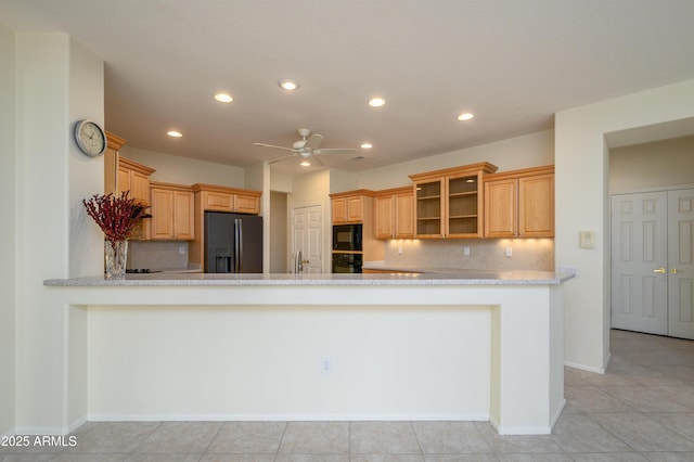 kitchen featuring glass insert cabinets, black appliances, a ceiling fan, and light countertops