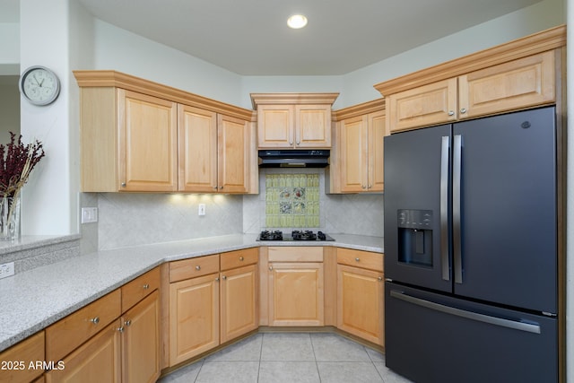 kitchen with black appliances, light brown cabinets, under cabinet range hood, backsplash, and light tile patterned floors