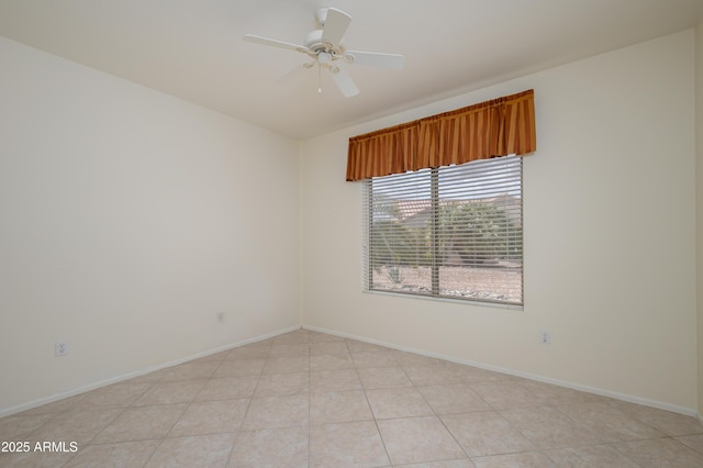 spare room with light tile patterned floors, baseboards, and ceiling fan