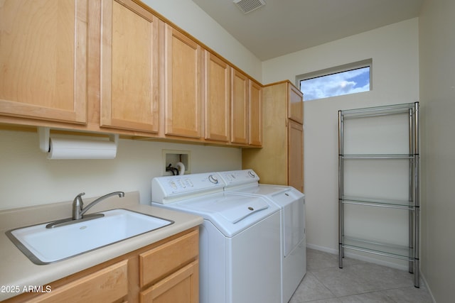 laundry area with light tile patterned floors, visible vents, cabinet space, a sink, and washer and clothes dryer