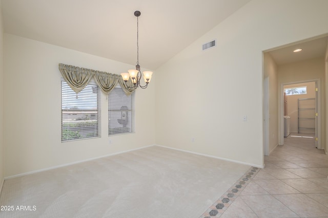 empty room featuring light tile patterned floors, baseboards, visible vents, lofted ceiling, and a chandelier