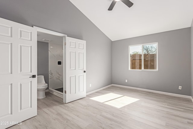 unfurnished bedroom with ceiling fan, connected bathroom, vaulted ceiling, and light wood-type flooring