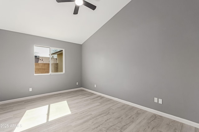 spare room featuring ceiling fan, lofted ceiling, and light hardwood / wood-style flooring