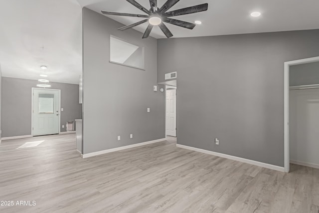 interior space with ceiling fan, high vaulted ceiling, and light hardwood / wood-style flooring