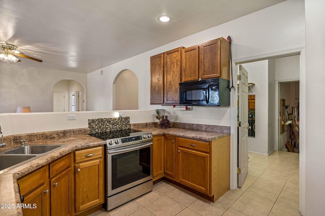 1970 Twin Pines Trl, Overgaard, AZ 85933 - kitchen with electric range, black microwave, a ceiling fan, and light tile patterned flooring
