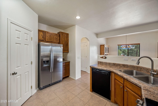 1970 Twin Pines Trl, Overgaard, AZ 85933 - kitchen featuring stainless steel fridge, black dishwasher, brown cabinetry, light tile patterned floors, and arched walkways