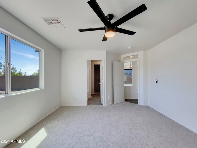 unfurnished bedroom featuring ceiling fan and carpet