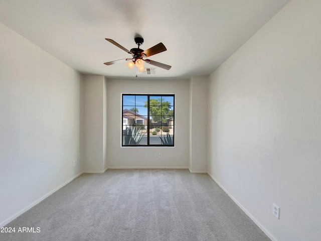 carpeted spare room with ceiling fan