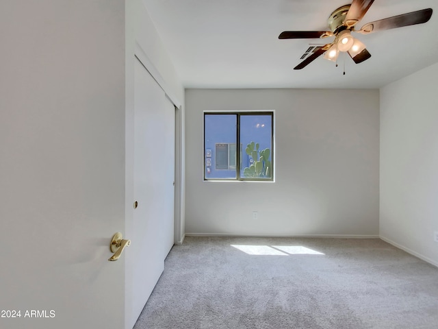 empty room with ceiling fan and carpet