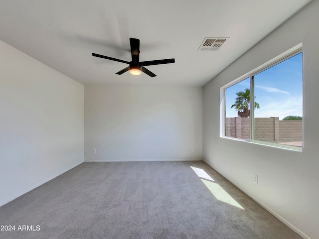 empty room with ceiling fan and carpet flooring