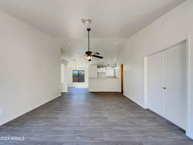 unfurnished living room with ceiling fan, vaulted ceiling, and hardwood / wood-style floors