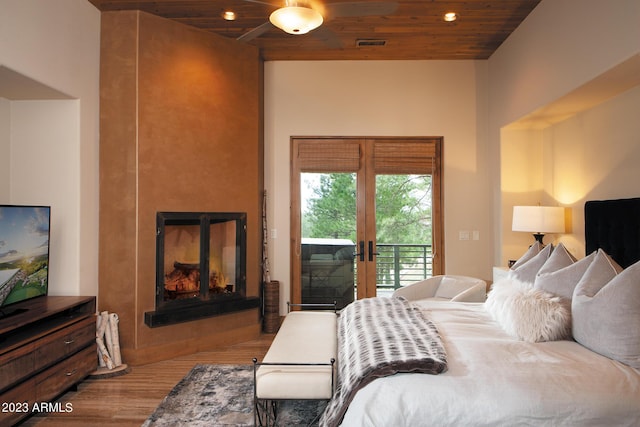 bedroom featuring wood ceiling, access to exterior, french doors, and light wood-type flooring