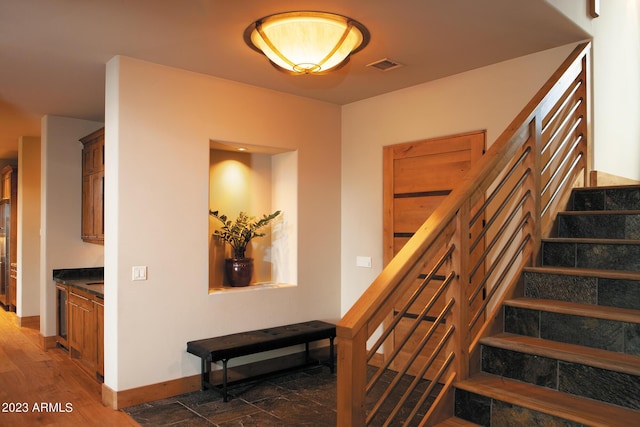 stairway featuring wood-type flooring