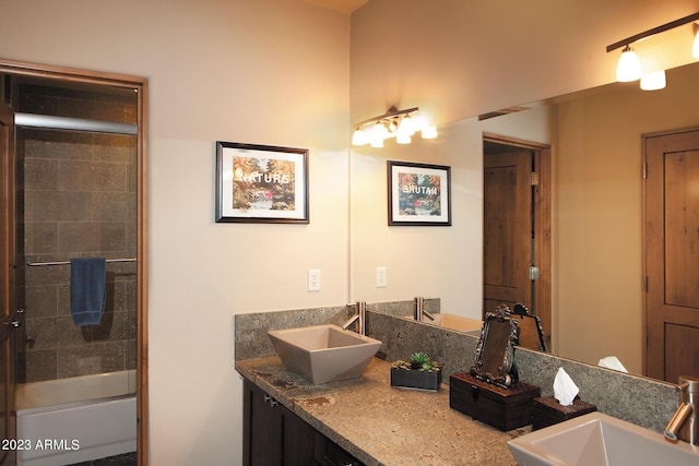 bathroom with vanity and shower / bath combination with glass door