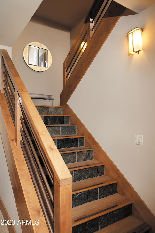 stairs featuring beam ceiling