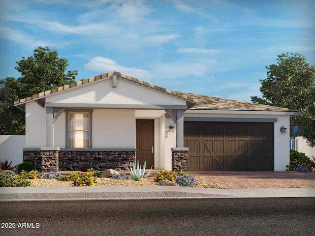 4041 S 176th Dr, Goodyear, AZ 85338 - view of front of house featuring decorative driveway, stone siding, an attached garage, and stucco siding
