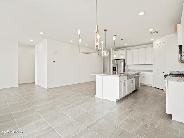4041 S 176th Dr, Goodyear, AZ 85338 - kitchen with appliances with stainless steel finishes, recessed lighting, light tile patterned flooring, open floor plan, and a kitchen island with sink