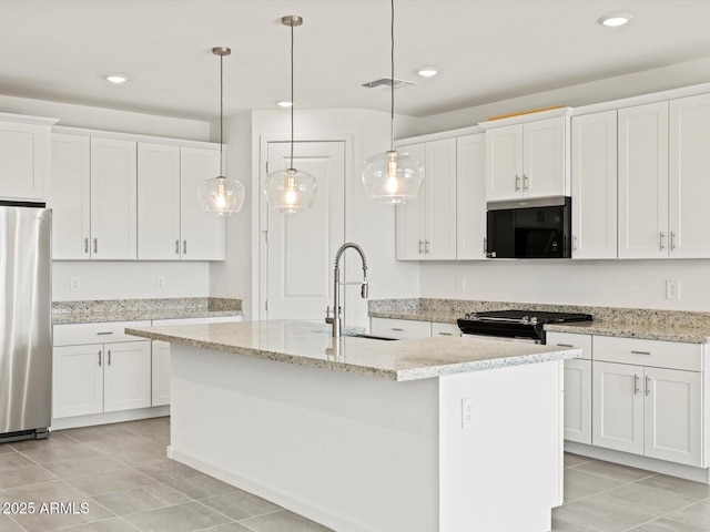 4041 S 176th Dr, Goodyear, AZ 85338 - kitchen featuring stainless steel appliances, light tile patterned floors, white cabinetry, a center island with sink, and pendant lighting