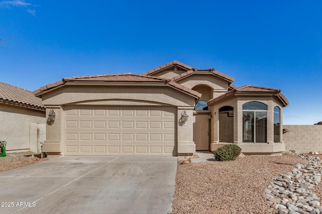 view of front of property with driveway, a garage, and stucco siding