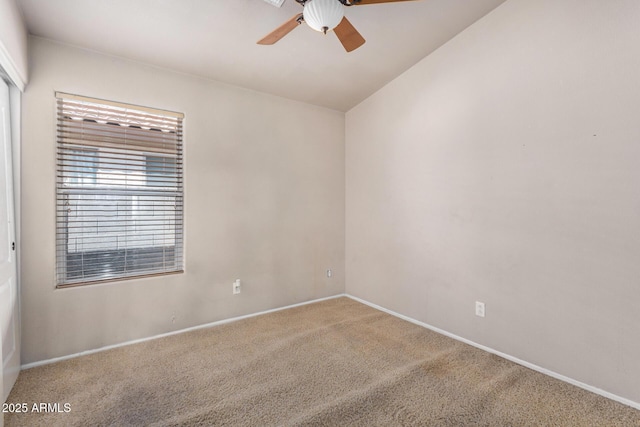 unfurnished room featuring carpet floors, ceiling fan, and baseboards