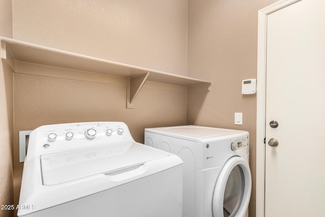 washroom featuring laundry area and separate washer and dryer