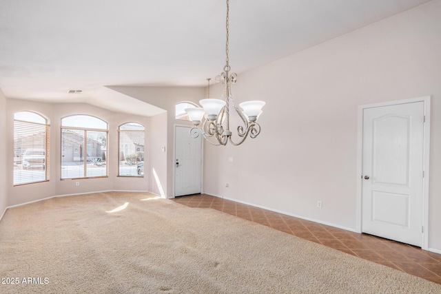 carpeted empty room with baseboards, visible vents, tile patterned flooring, vaulted ceiling, and a notable chandelier