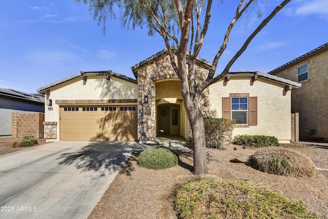 view of front of home featuring an attached garage, stone siding, concrete driveway, and stucco siding