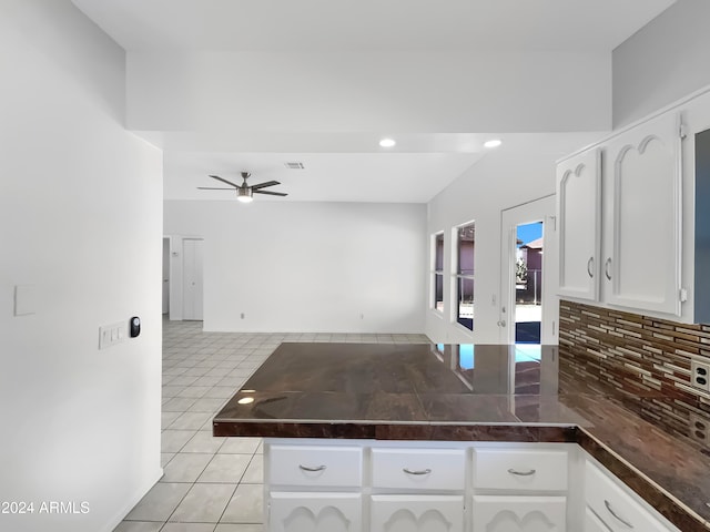 kitchen featuring white cabinetry, light tile patterned floors, decorative backsplash, kitchen peninsula, and ceiling fan