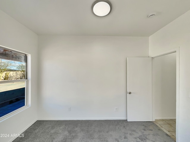 empty room featuring light colored carpet