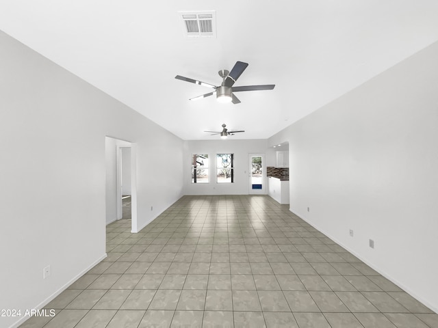 unfurnished living room featuring ceiling fan and light tile patterned floors