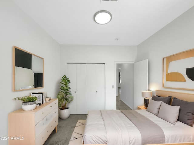 bedroom featuring a closet and light colored carpet