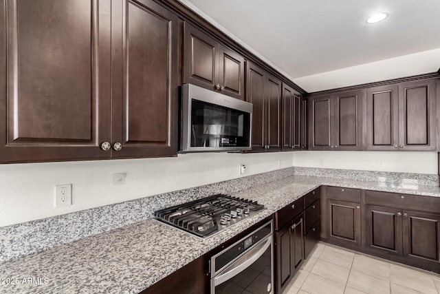 kitchen with stainless steel appliances and dark brown cabinets