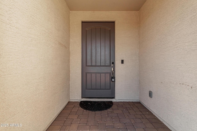 property entrance featuring stucco siding