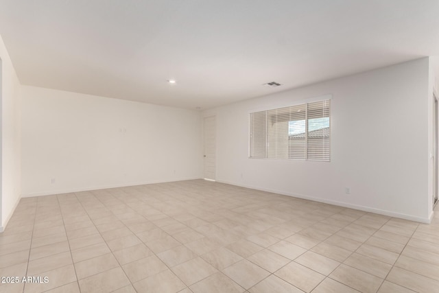 empty room featuring visible vents and baseboards