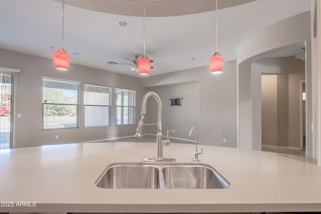 kitchen featuring pendant lighting, a sink, and open floor plan