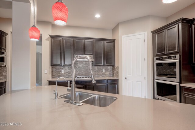 kitchen featuring double oven, light countertops, and dark brown cabinetry