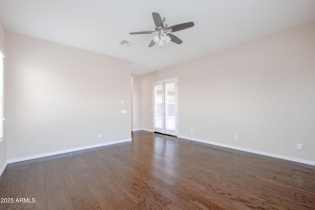 unfurnished room featuring a ceiling fan, dark wood-style flooring, visible vents, and baseboards