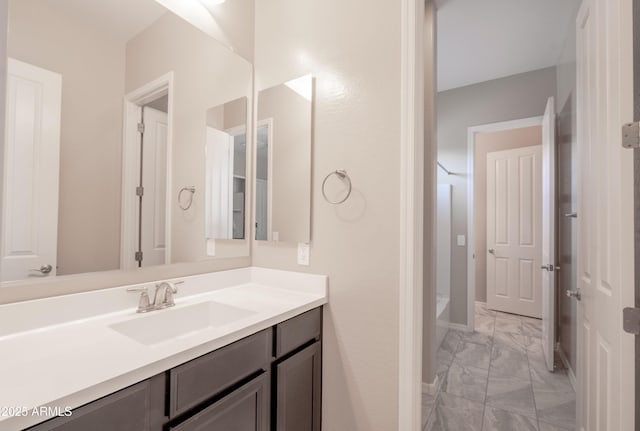 bathroom featuring marble finish floor and vanity