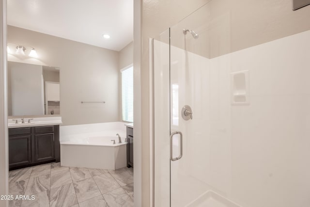 full bath featuring a garden tub, vanity, and a stall shower