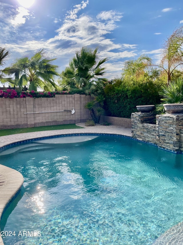 view of swimming pool with fence and a fenced in pool