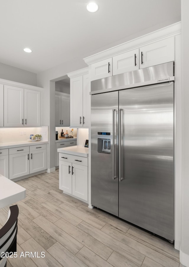 8149 E Jaeger St, Mesa, AZ 85207 - kitchen featuring built in refrigerator, recessed lighting, white cabinetry, light wood-type flooring, and light countertops