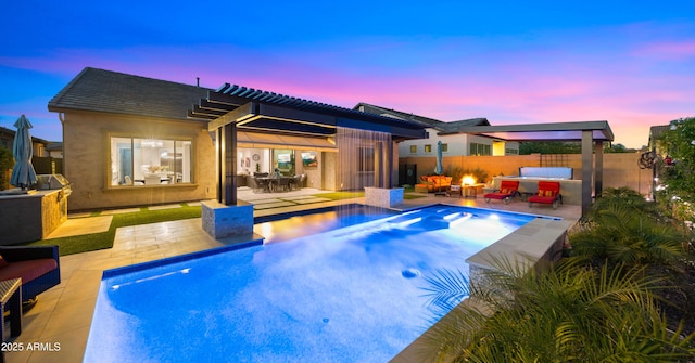 8149 E Jaeger St, Mesa, AZ 85207 - back of house at dusk featuring a patio area, a fenced backyard, and exterior kitchen