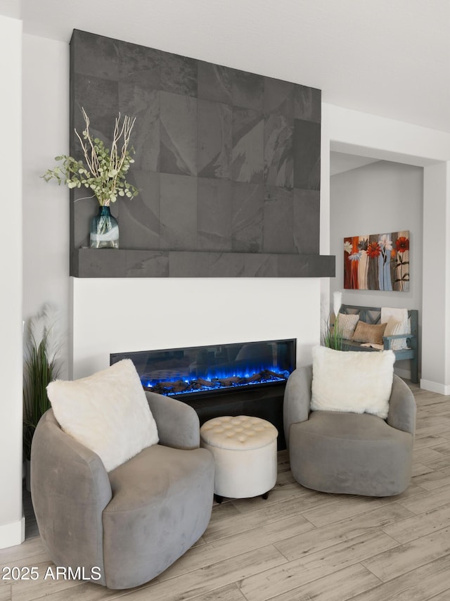 8149 E Jaeger St, Mesa, AZ 85207 - living room featuring wood finished floors, a glass covered fireplace, and baseboards