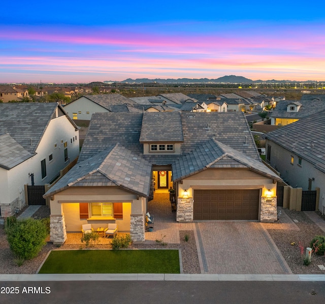 8149 E Jaeger St, Mesa, AZ 85207 - view of front of house with stone siding, a residential view, a garage, fence, and decorative driveway