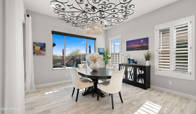 8149 E Jaeger St, Mesa, AZ 85207 - dining space with a chandelier, wood finished floors, and baseboards